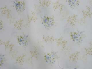   roses form a garland across this pretty fabric on a white background
