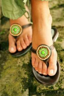 Woman wearing trendy sandals with a beaded embellishment