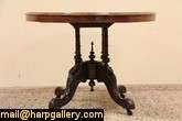 Expertly hand carved of walnut about 1870, this stellar oval table has 